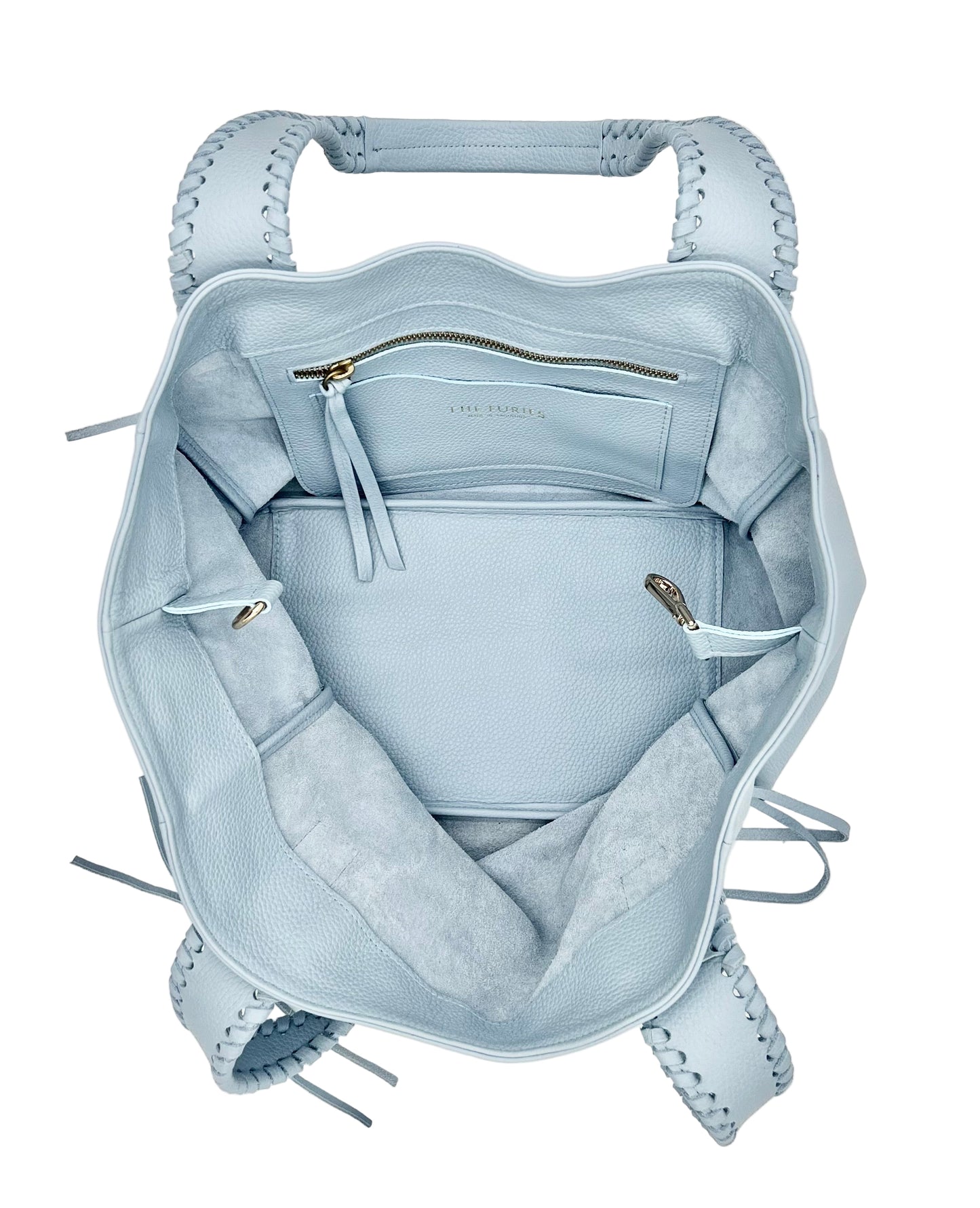 Light blue handbag interior with interior pocket and card holder with logo The Furies and Made in Argentina