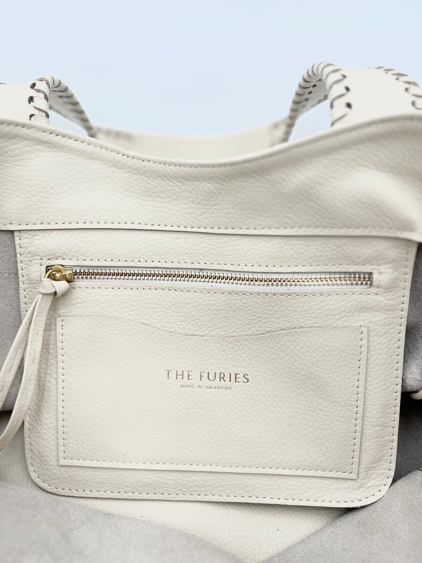 Off white handbag interior pocket with zipper and cardholder.