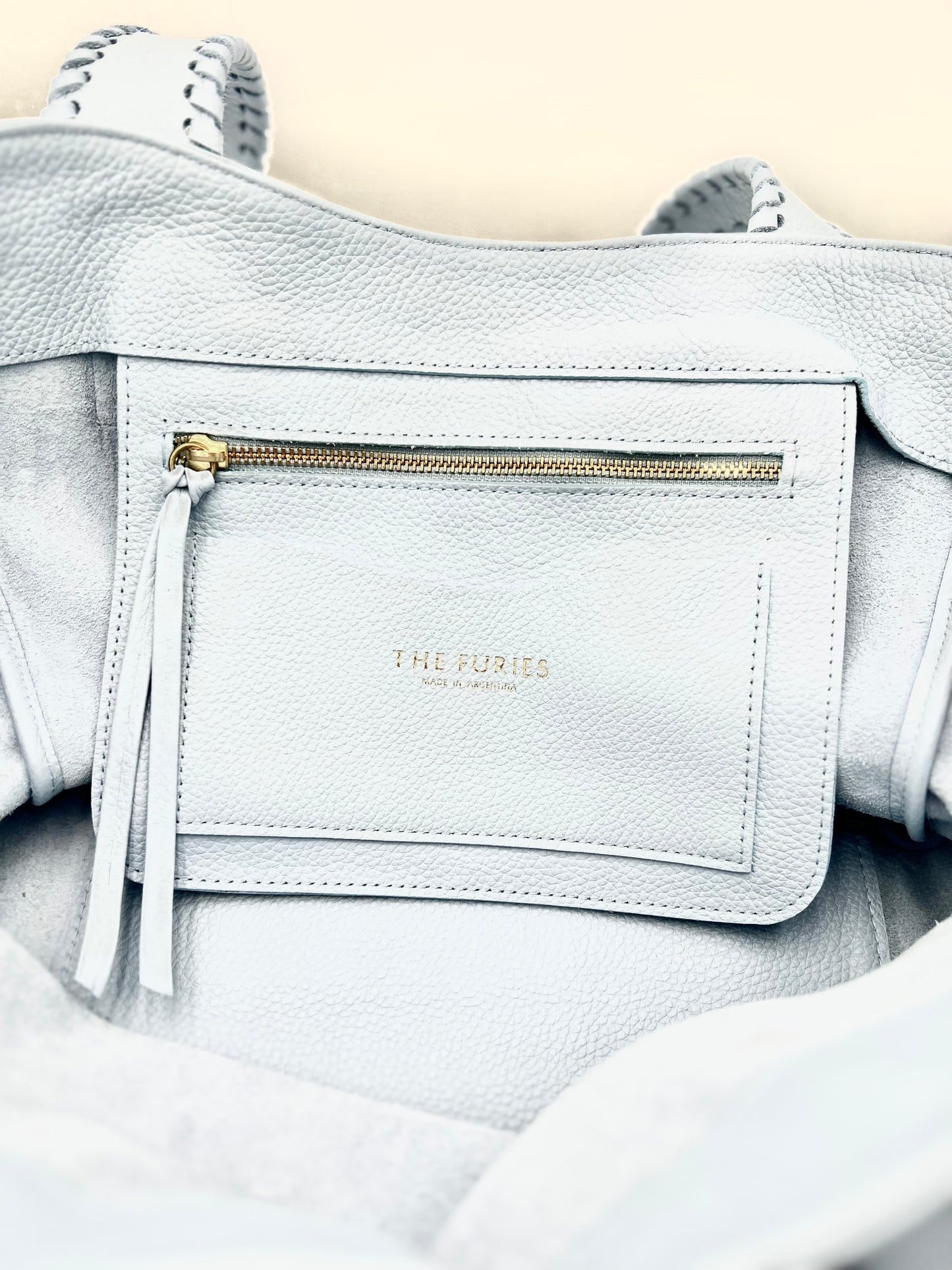 Light blue handbag interior pocket and card holder with logo The Furies and Made in Argentina