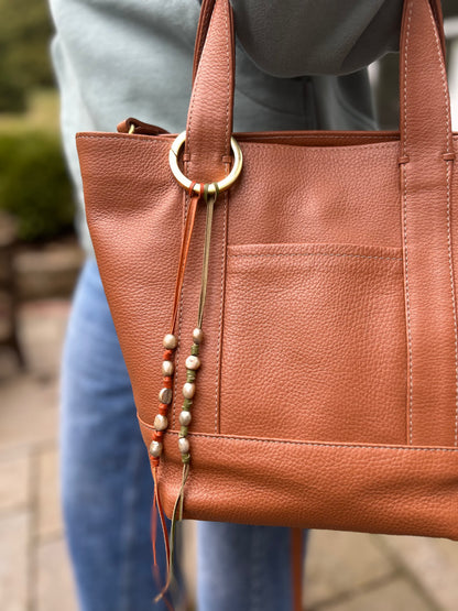 The Lady with a Pearl (Espresso) bag charm from The Furies Collective — beaded charm on leather lace for handbag styling.