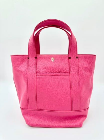The Small Carolyn crossbody handbag from The Furies Collective in Raspberry — pebble leather with zip top and exterior pocket.