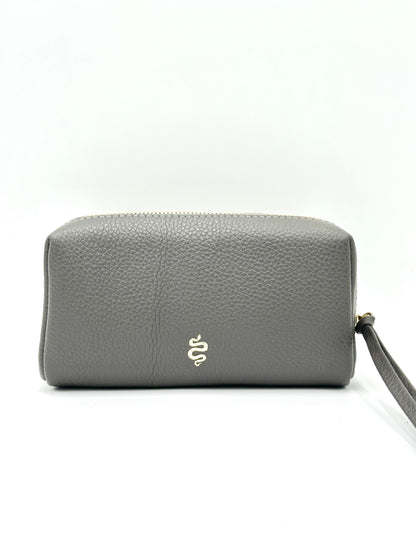 The Small Makeup Bag from The Furies Collective in Anthracite with a Grey Clouds Interior — pebble leather pouch with brass zipper for cosmetics.