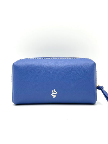 The Small Makeup Bag from The Furies Collective in Sapphire with a Silver Interior — pebble leather pouch with brass zipper for cosmetics.