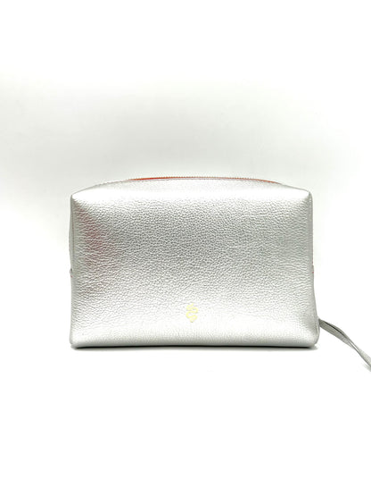 The Large Accessories Bag from The Furies Collective in Silver with a Lipstick Red Interior — pebble leather travel pouch lined in contrast color.