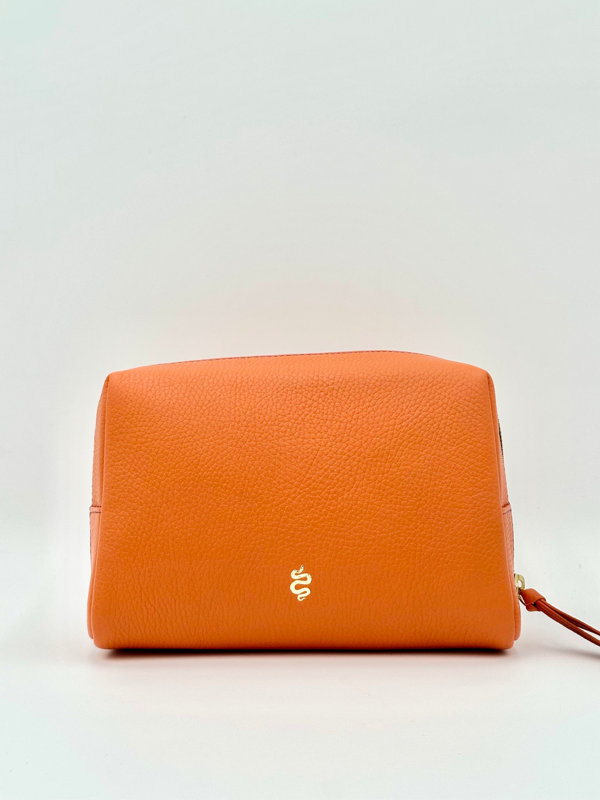 The Large Accessories Bag from The Furies Collective in Bright Orange with a Sapphire Interior — pebble leather travel pouch lined in contrast color.