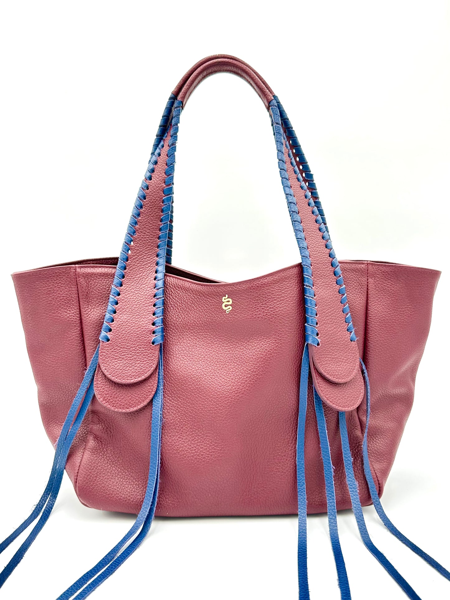 The Talitha tote handbag from The Furies Collective in Claret with Navy Lacing — pebble leather with whipstitched fringe handles and the Furies snake logo.