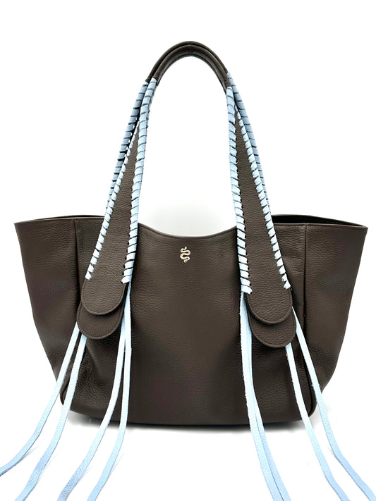 The Talitha tote handbag from The Furies Collective in Espresso with Sky Blue Lacing — pebble leather with whipstitched fringe handles and the Furies snake logo.