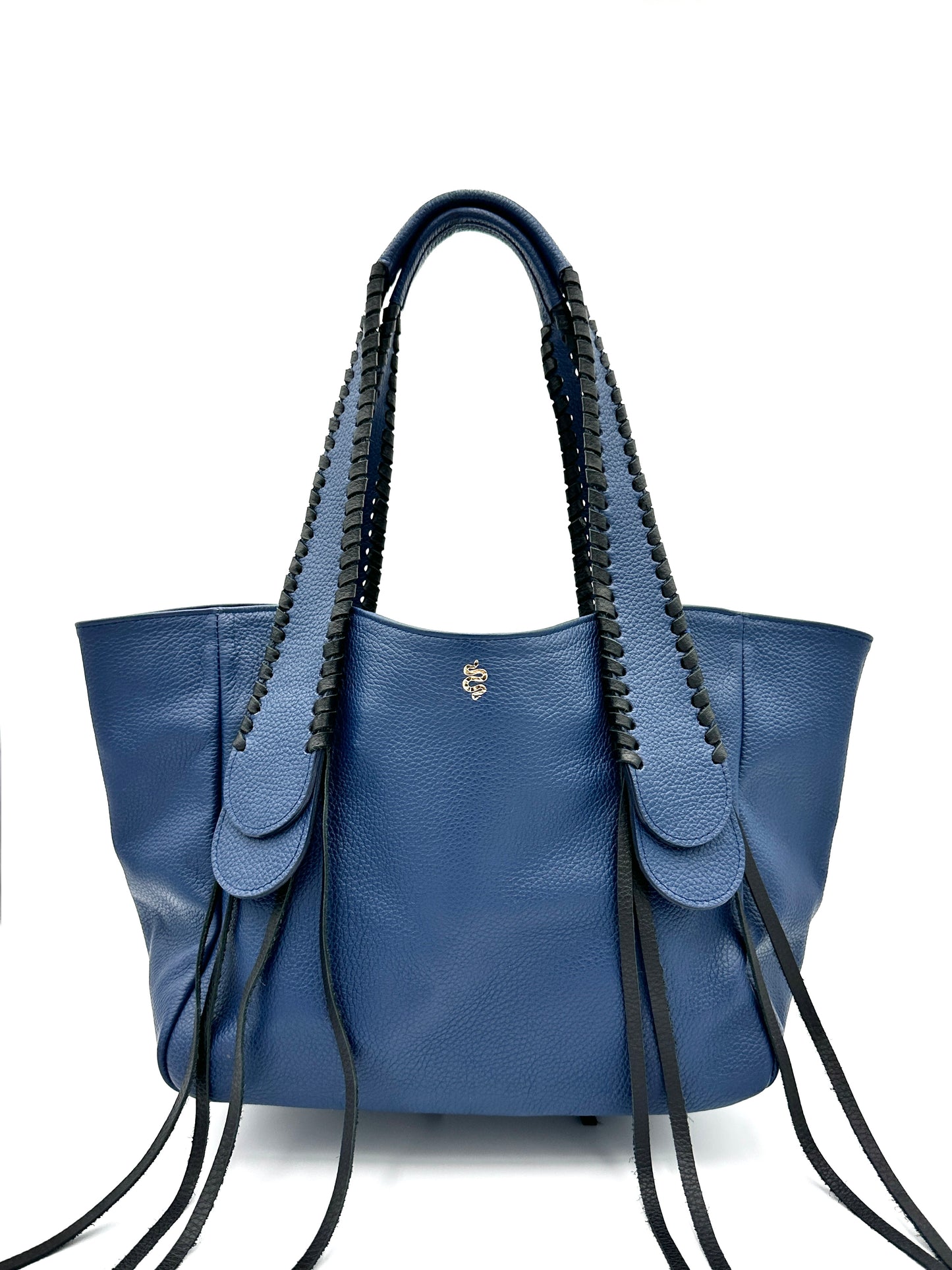 The Talitha tote handbag from The Furies Collective in Navy with Black Lacing — pebble leather with whipstitched fringe handles and the Furies snake logo.