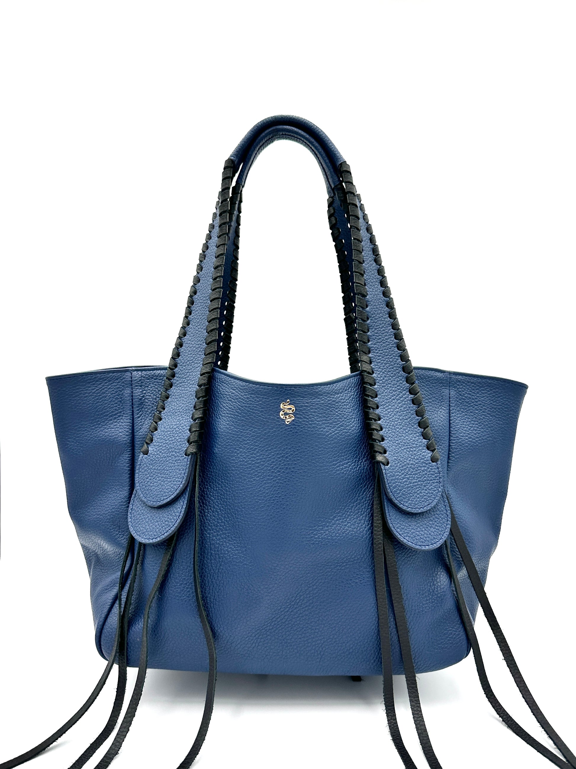 The Talitha tote handbag from The Furies Collective in Navy with Black Lacing — pebble leather with whipstitched fringe handles and the Furies snake logo.