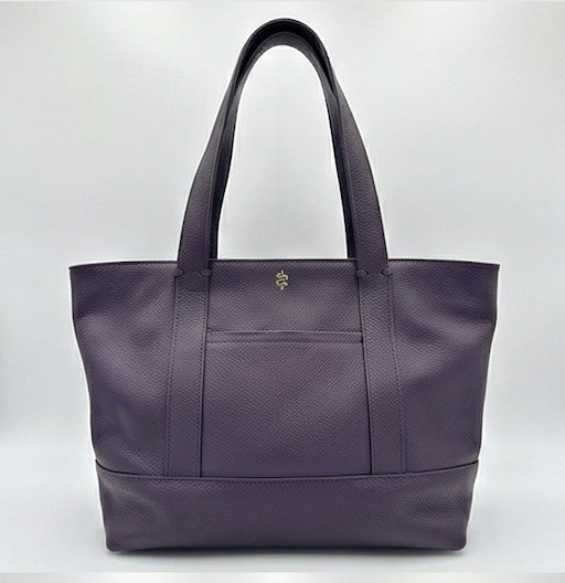 The Large Carolyn tote handbag from The Furies Collective in Eggplant — saturated pebble leather with thick handles and zipper top closure.