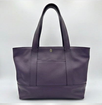 The Large Carolyn tote handbag from The Furies Collective in Eggplant — saturated pebble leather with thick handles and zipper top closure.