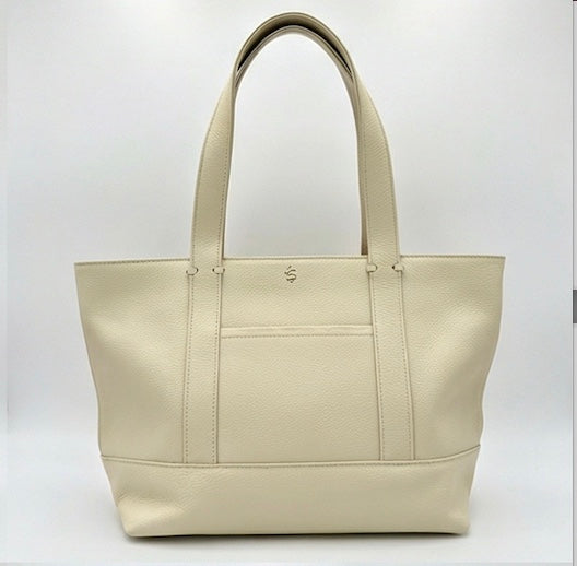 The Large Carolyn tote handbag from The Furies Collective in Champagne — saturated pebble leather with thick handles and zipper top closure.