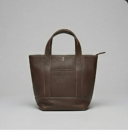 The Small Carolyn crossbody handbag from The Furies Collective in Espresso — pebble leather with zip top and exterior pocket.