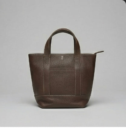 The Small Carolyn crossbody handbag from The Furies Collective in Espresso — pebble leather with zip top and exterior pocket.