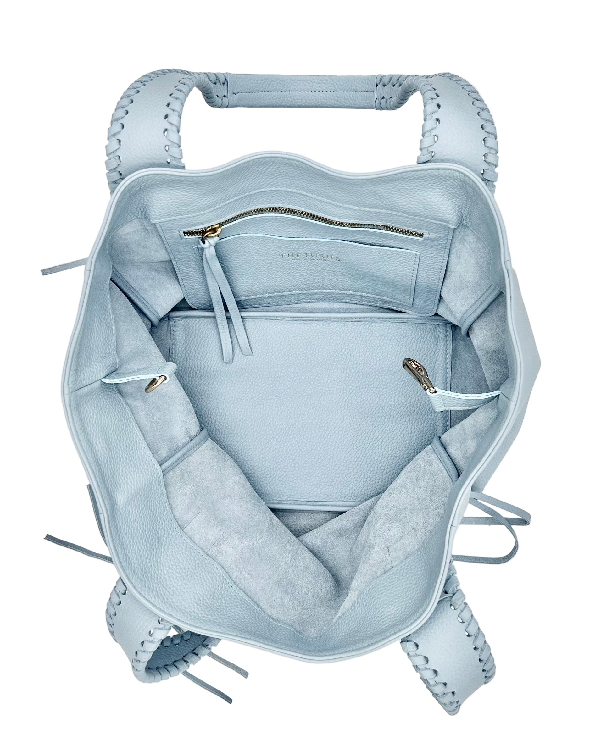 Light blue handbag interior with interior pocket and card holder with logo The Furies and Made in Argentina