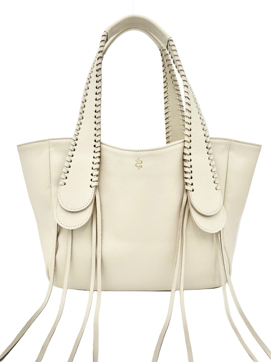 A beige handbag with textured pebble leather, featuring whipstitched detailing on handles and fringe. The bag has a large main compartment and a snake logo.