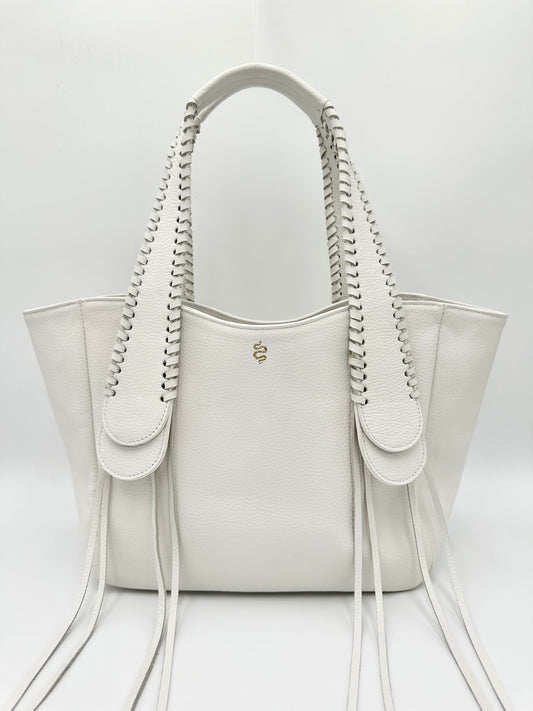 A white pebble leather handbag with whipstitched detailing on the handles and a fringe design, viewed from the front and snake logo
