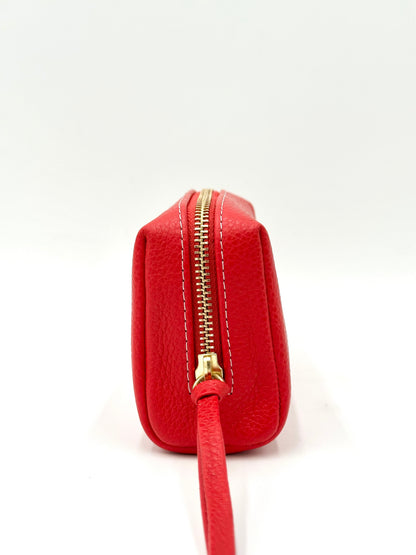 Red pouch with a gold zipper on a white background
