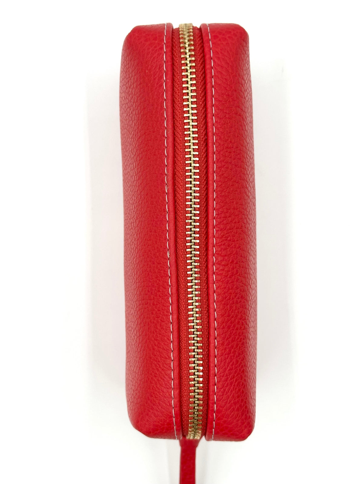 Red leather makeup case with a gold zipper on a white background